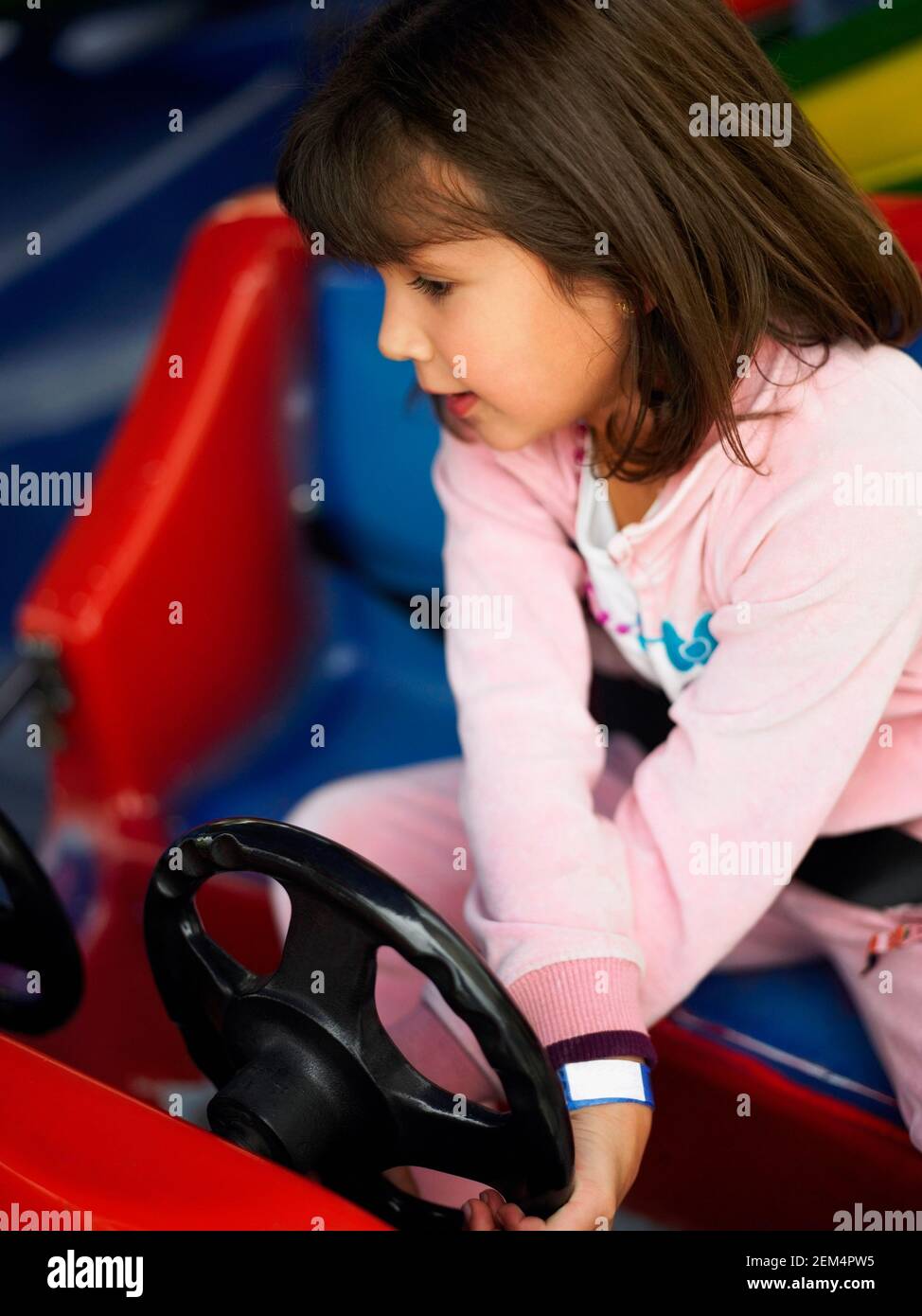 High angle view of a girl riding a bumper car Stock Photo