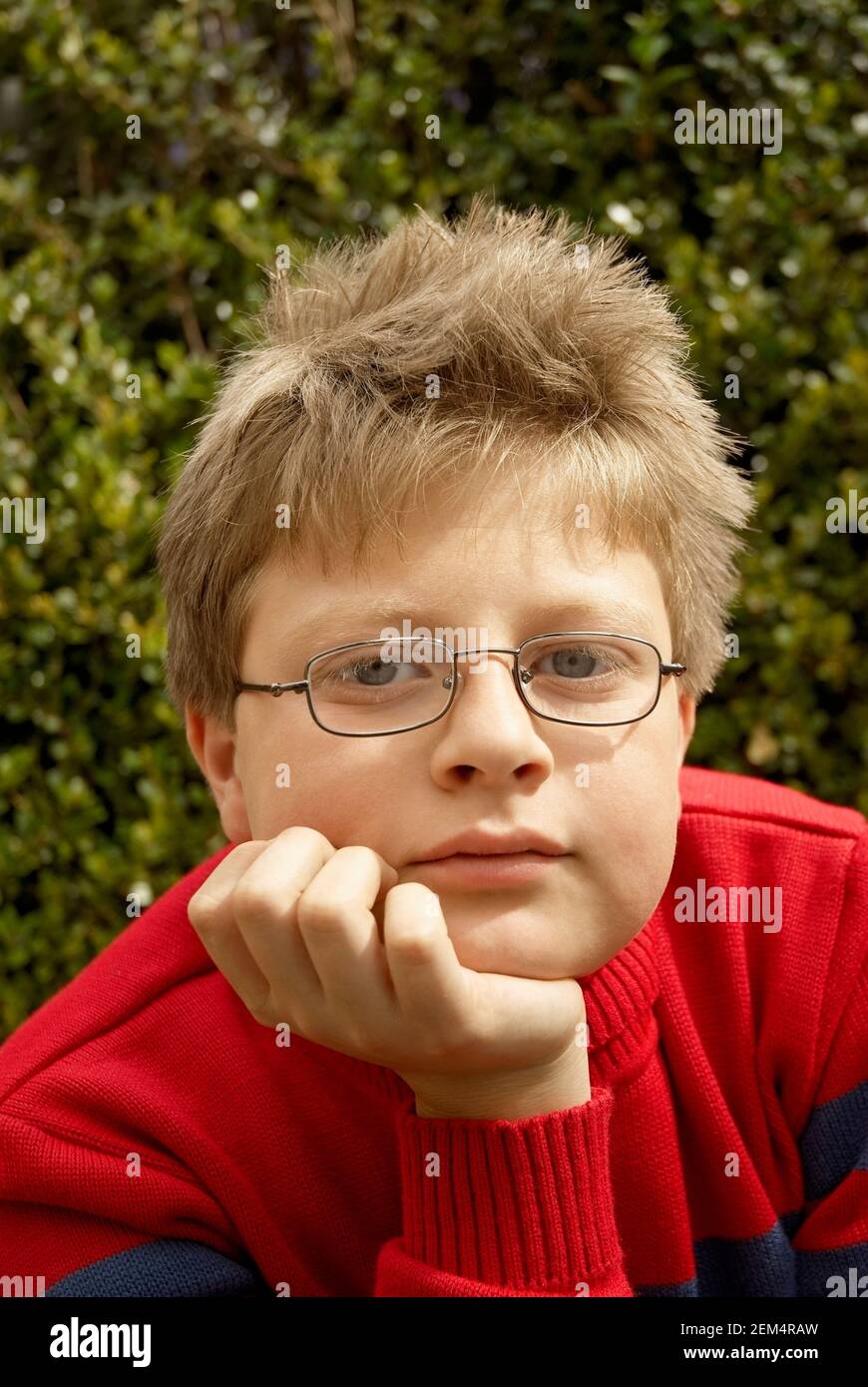 Portrait of a boy with his hand on his chin Stock Photo