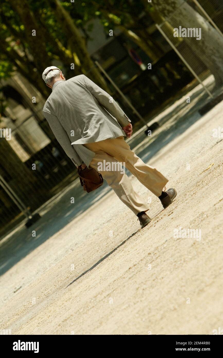 Rear view of a man walking Stock Photo