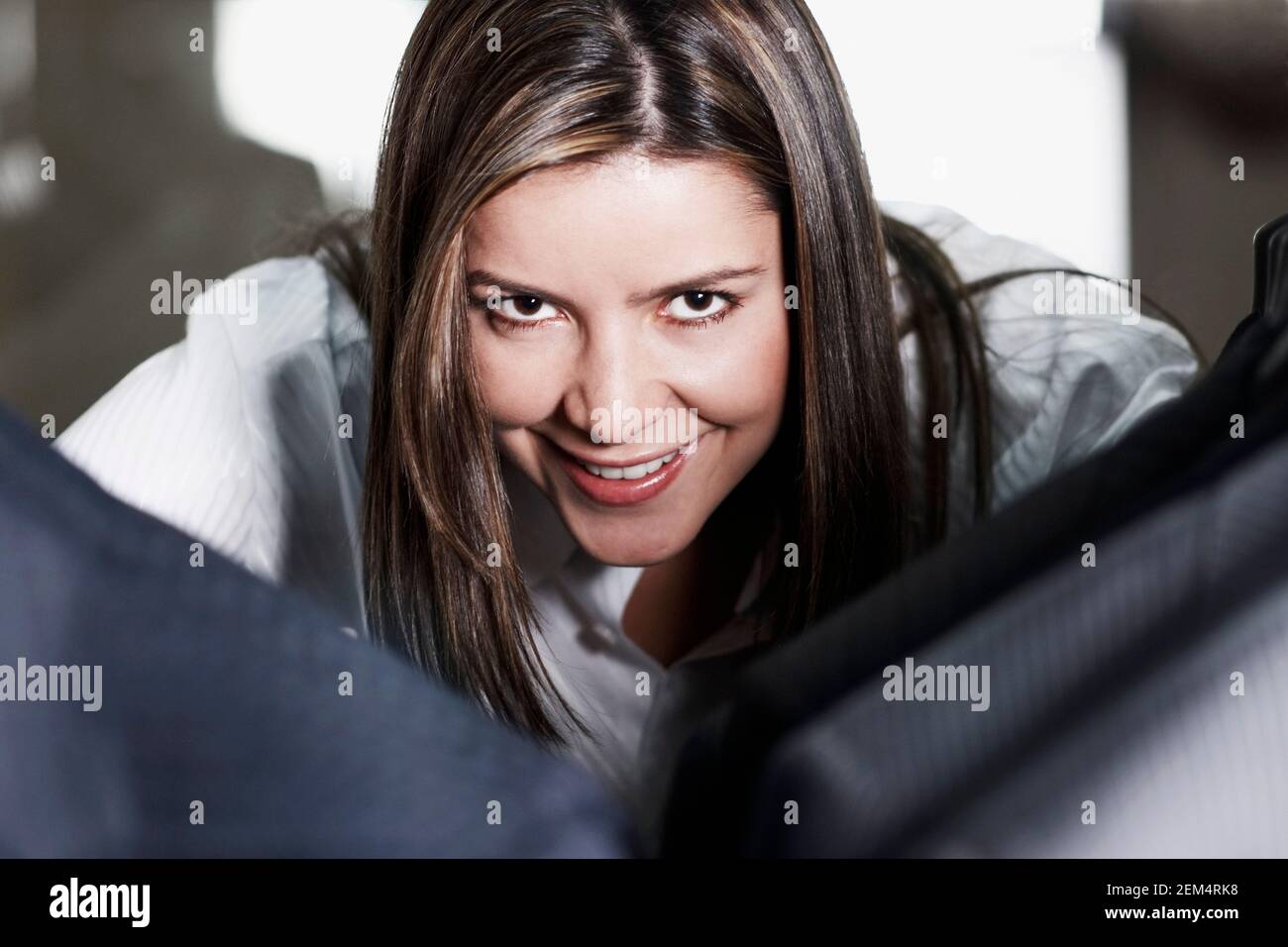 Close-up of a young woman looking at jackets Stock Photo
