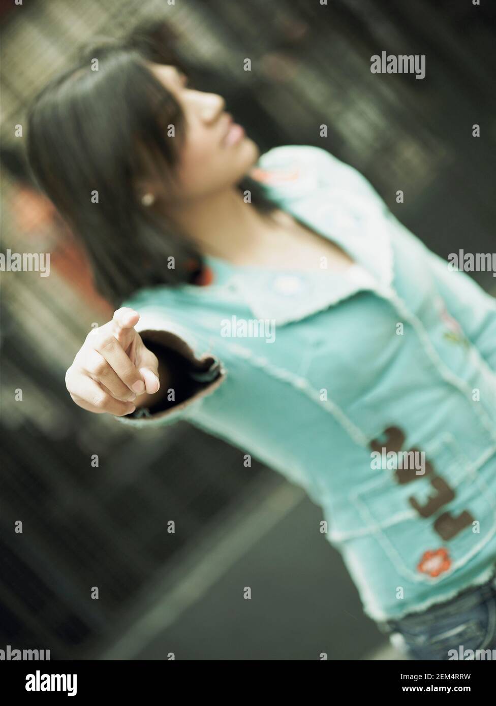 Close-up of a young woman hailing a vehicle Stock Photo