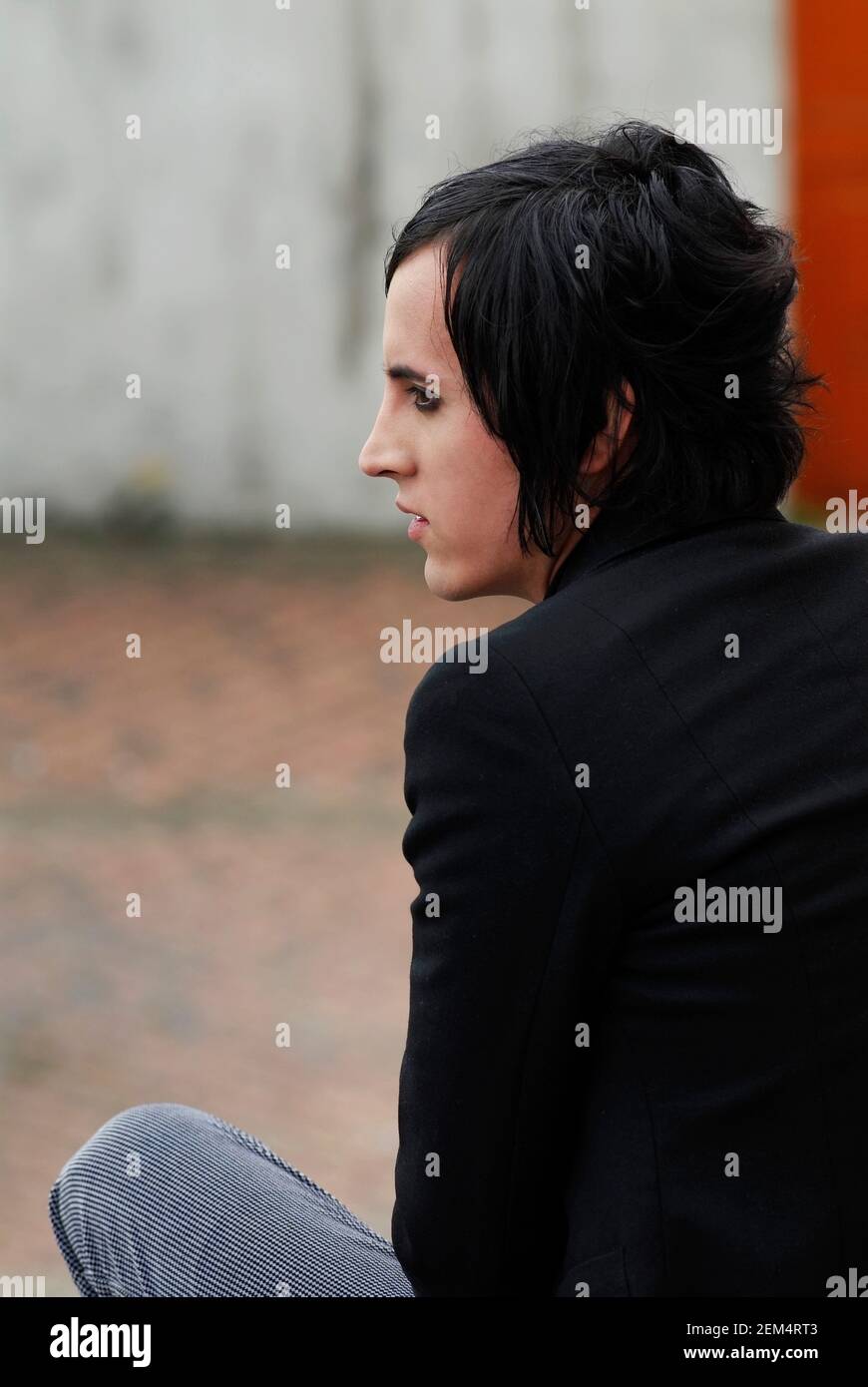 Rear view of a young man sitting Stock Photo - Alamy