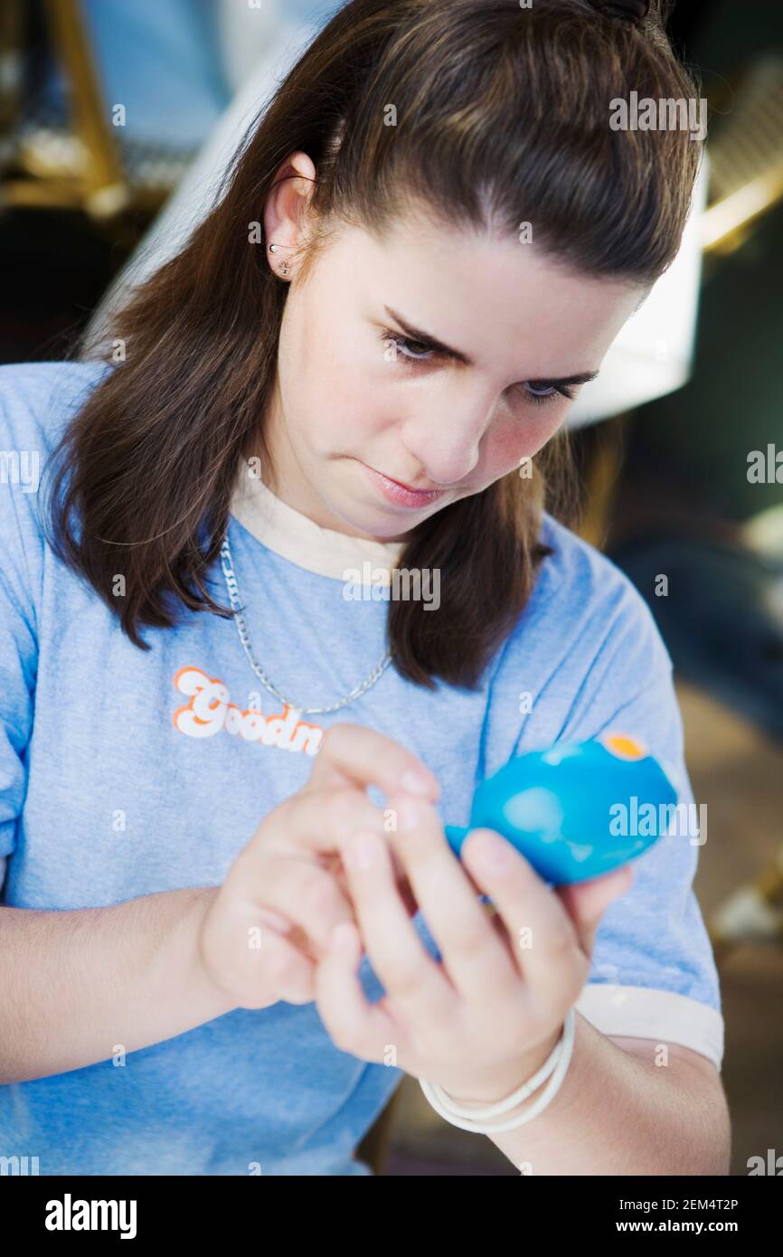 Close-up of a teenage girl looking at a hand mirror Stock Photo