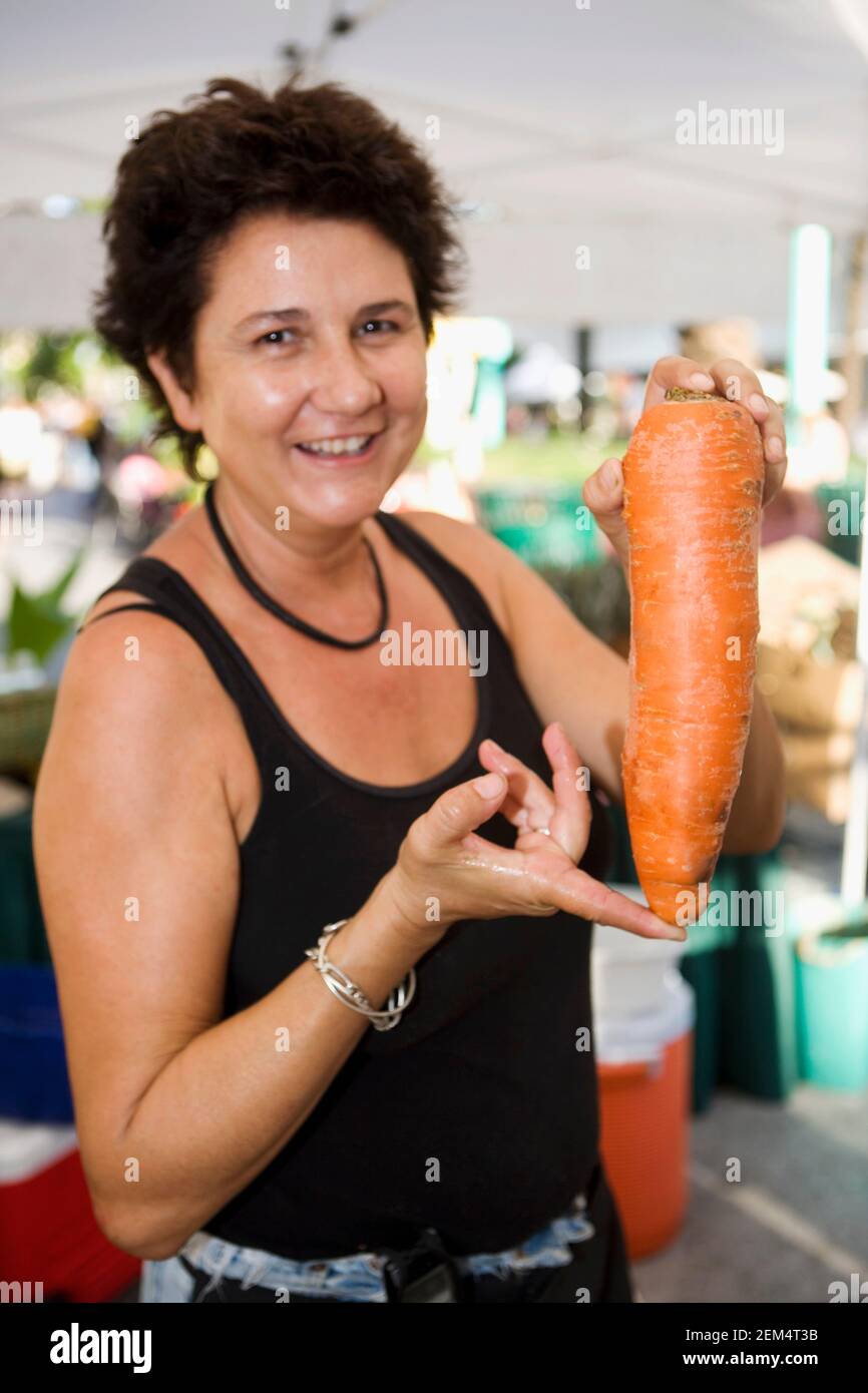 Portrait of a mature woman holding a carrot Stock Photo