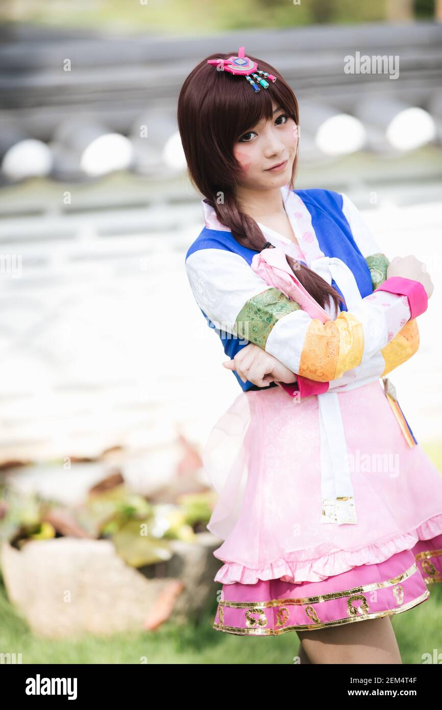Portrait of Hanbok costume young woman looking and smile in korean park Stock Photo