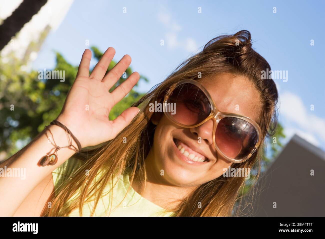 Close-up of a mid adult woman waving her hand Stock Photo
