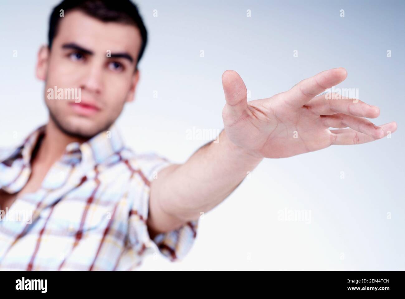 Close-up of a young man gesturing Stock Photo