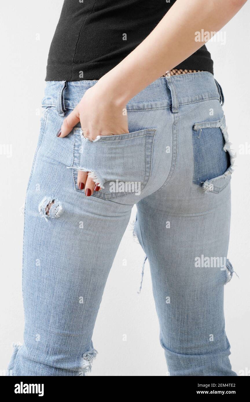 Mid section view of a woman with her hand in her torn pocket Stock Photo