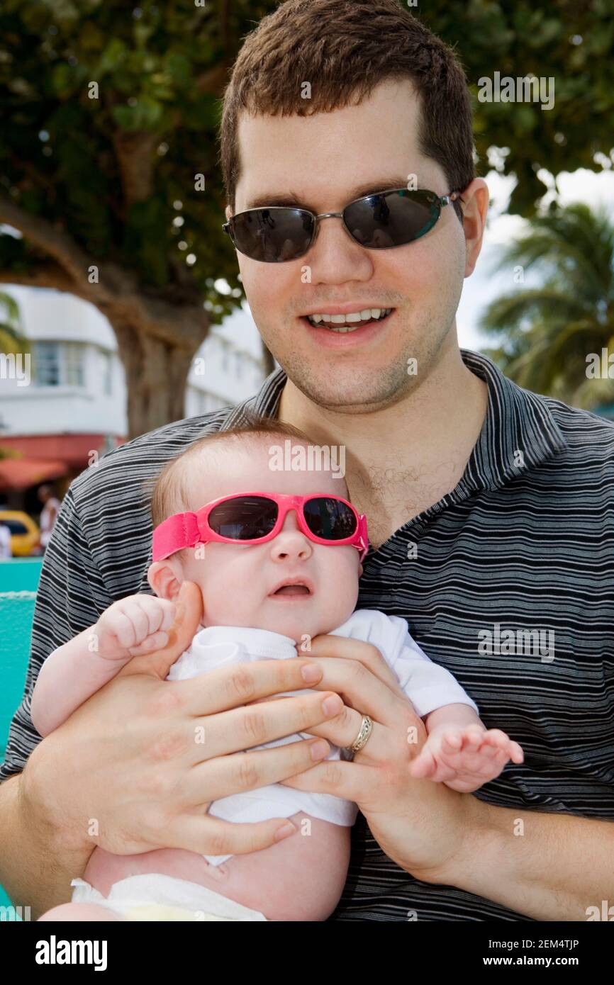 Close-up of a young man carrying his son Stock Photo