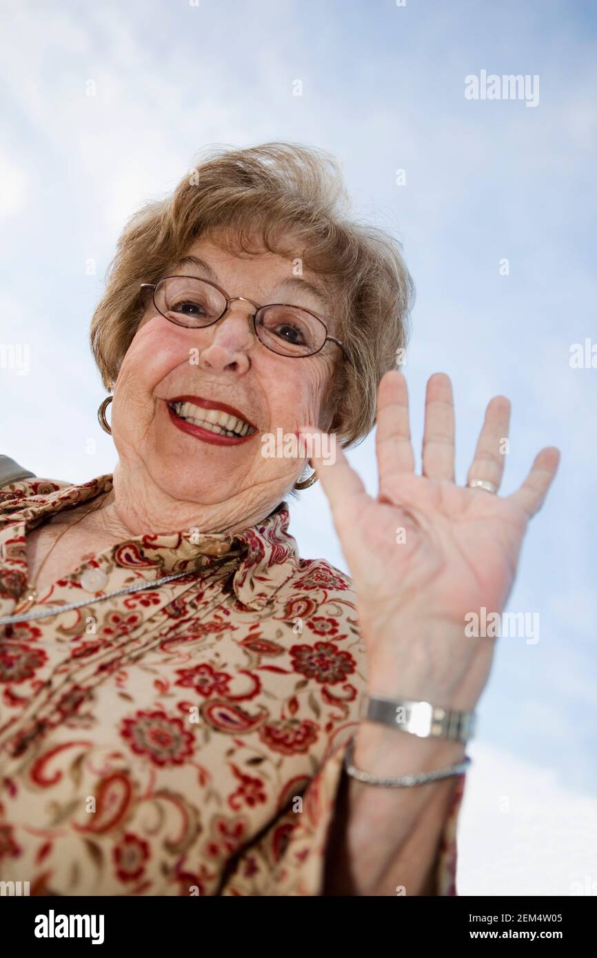 Portrait of a senior woman smiling and gesturing Stock Photo