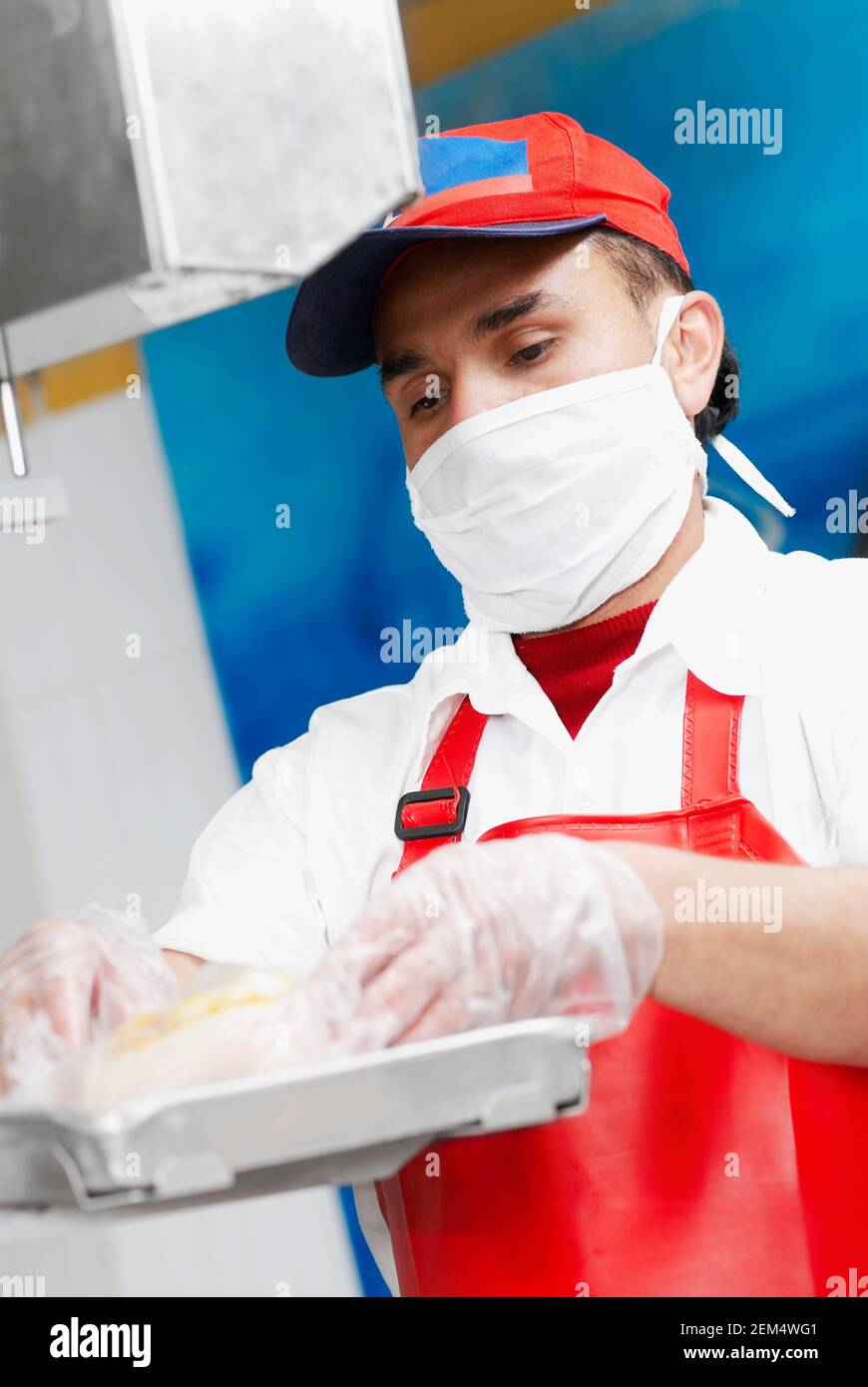 Close-up of a butcher weighing meat in a butcher shop Stock Photo