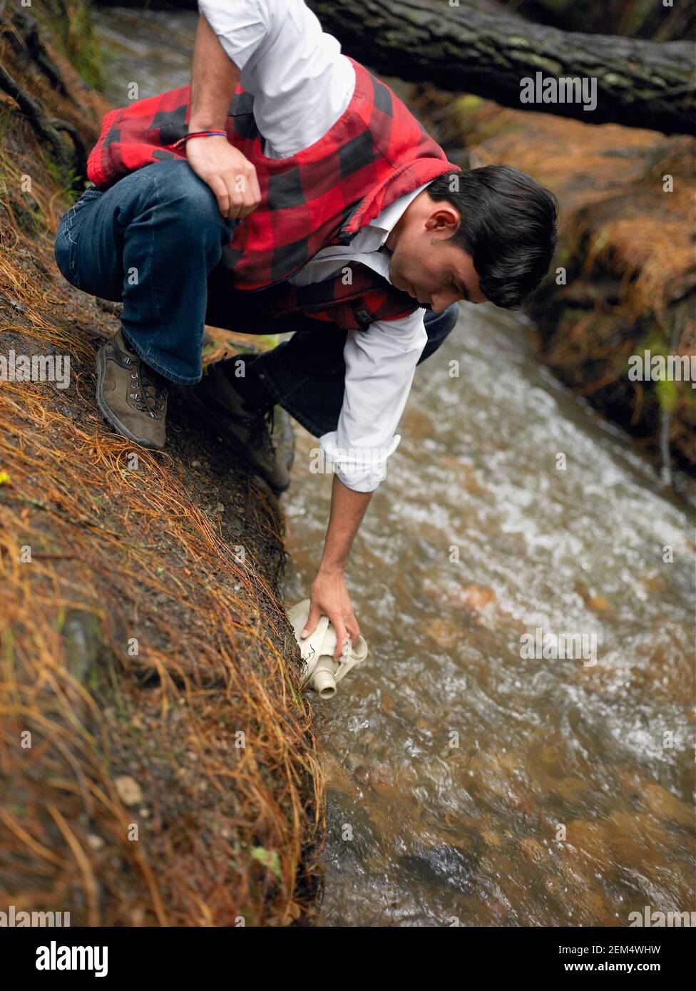 Young man filling a bottle Stock Photo