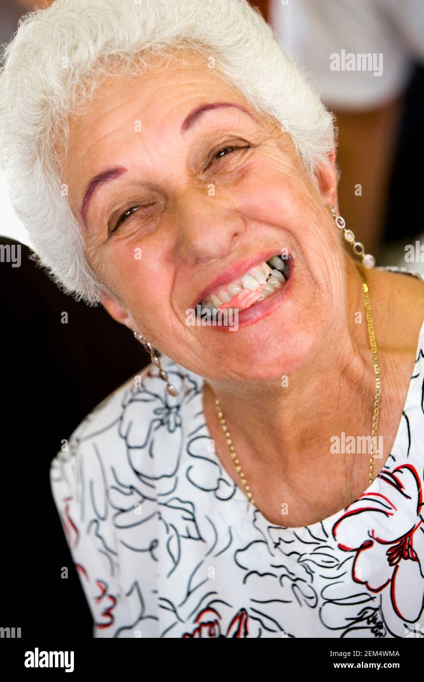 Portrait of a senior woman showing bubble gum in her mouth Stock Photo