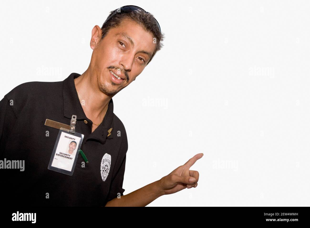 Portrait of a security guard pointing towards the mural of a man Stock ...