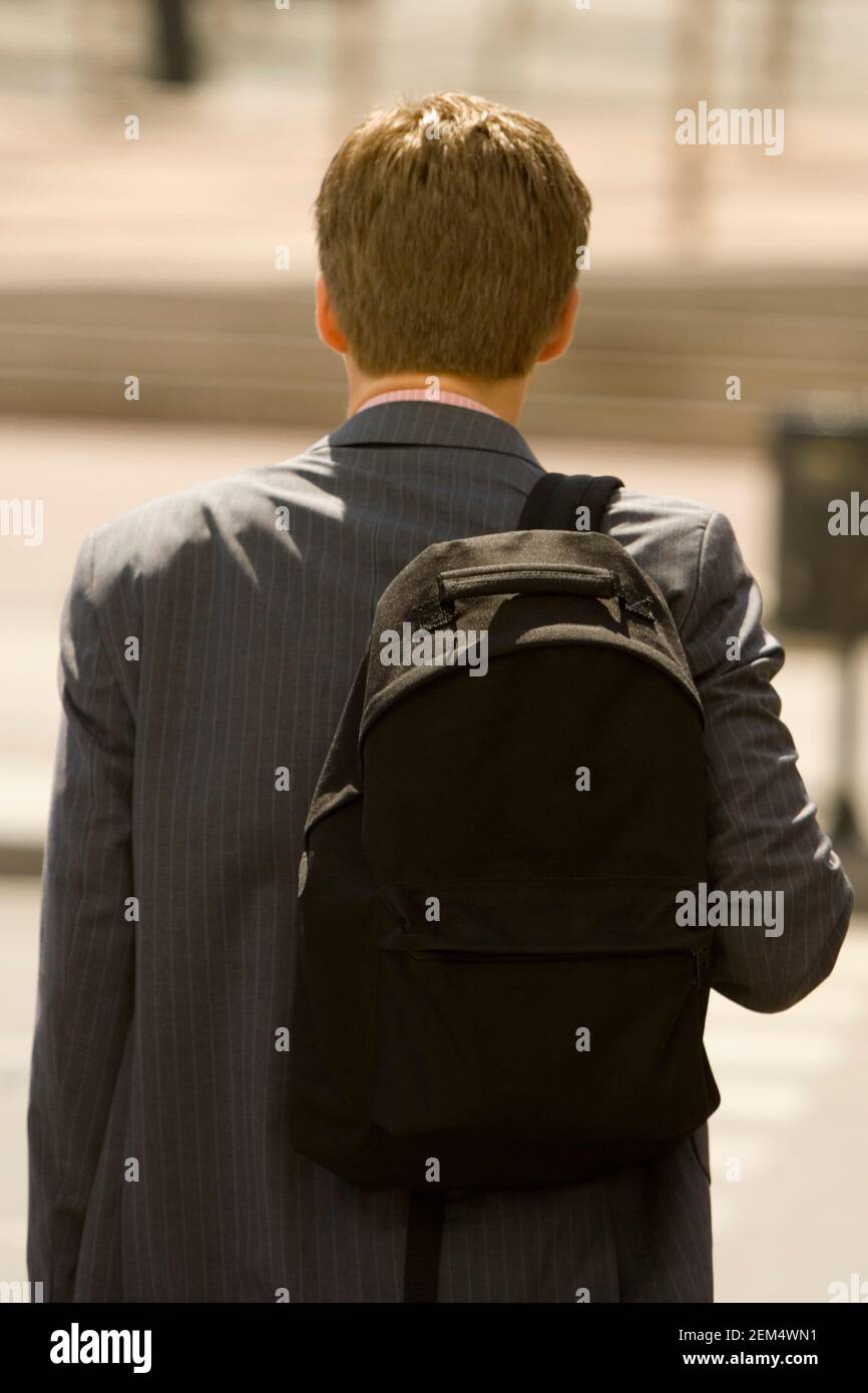 Rear view of a man carrying a bag on his shoulders Stock Photo Alamy