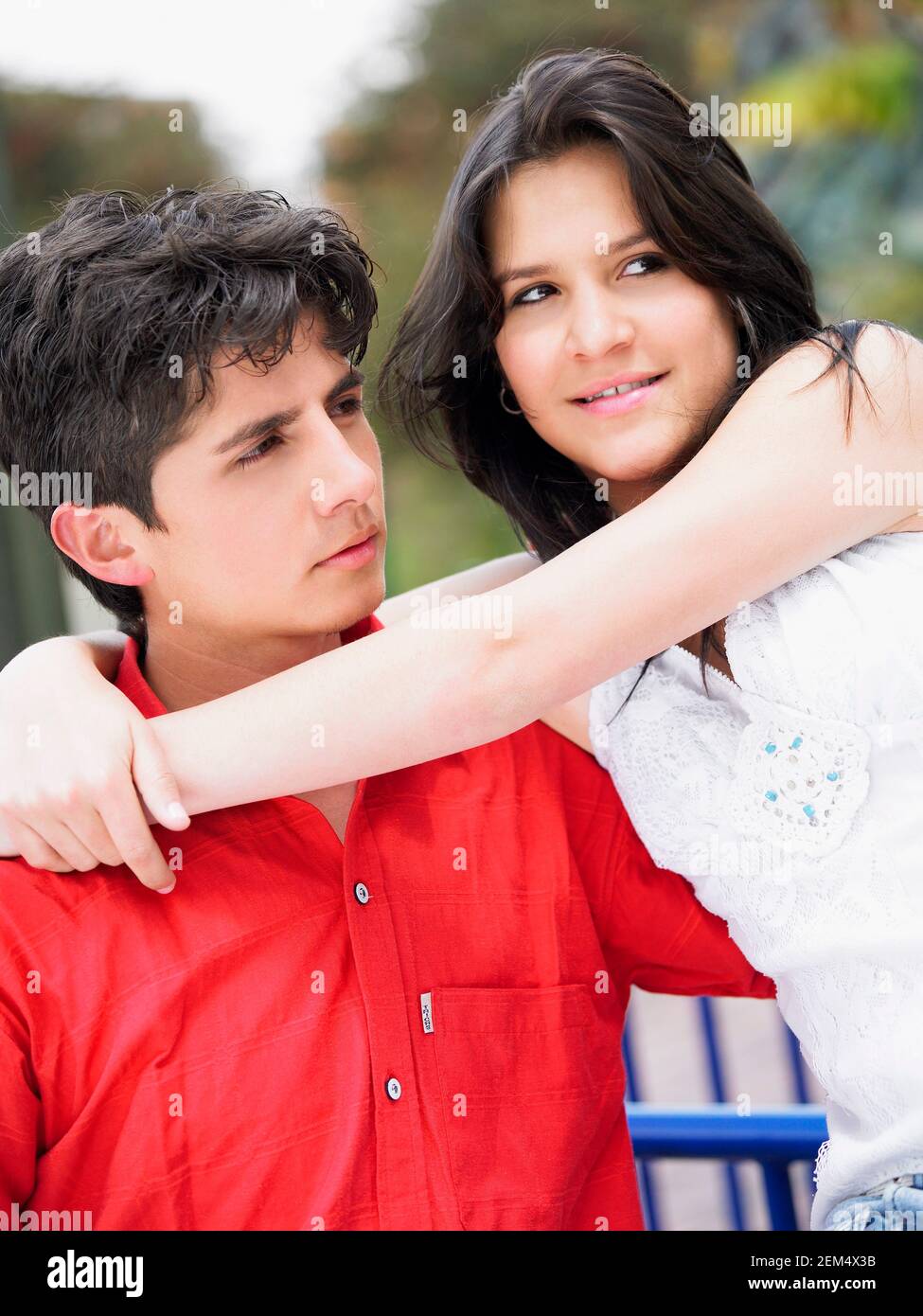 Close-up of a teenage girl with her arm around a young man Stock Photo