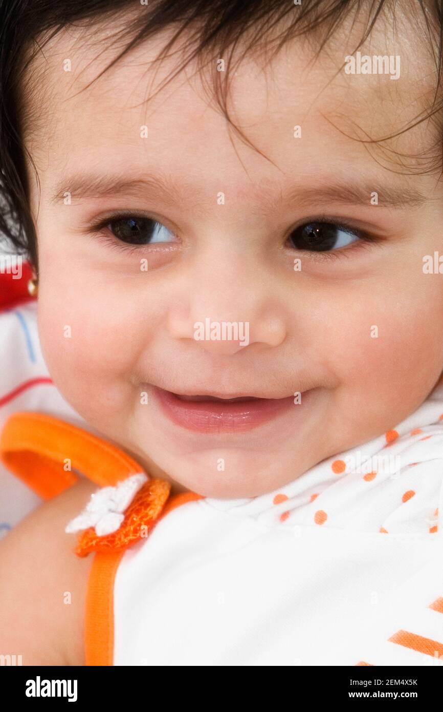 Close-up of a baby girl smiling Stock Photo