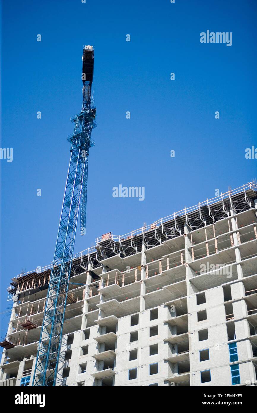 Low angle view of a crane at a construction site Stock Photo - Alamy