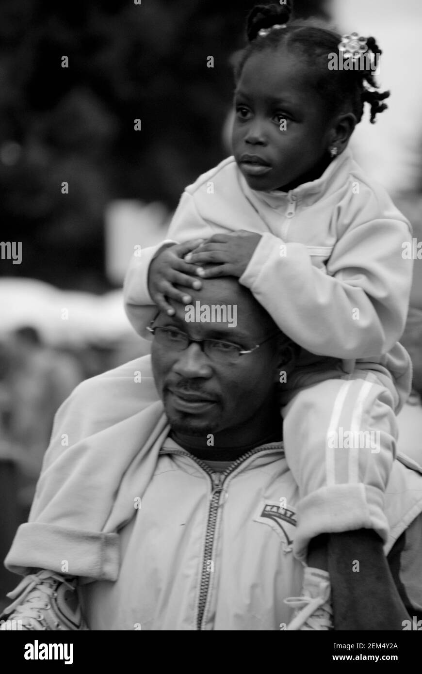 Mid adult man carrying his daughter on his shoulders Stock Photo