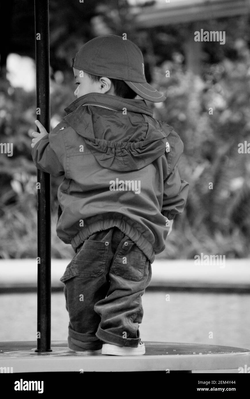 Rear view of a child standing on the table Stock Photo