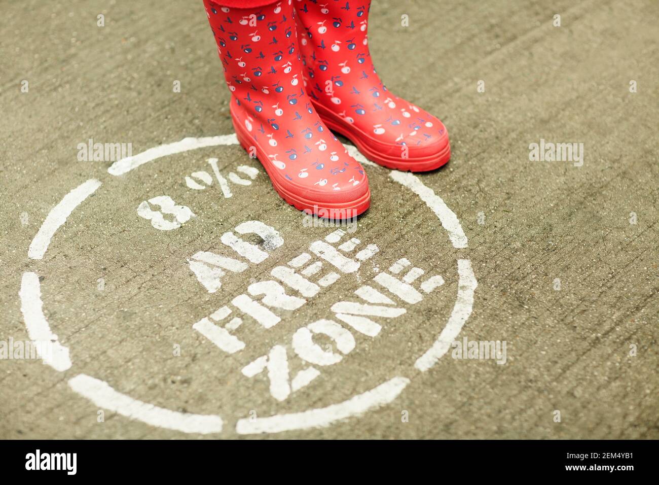 High angle view of a pair of galoshes on a warning sign Stock Photo