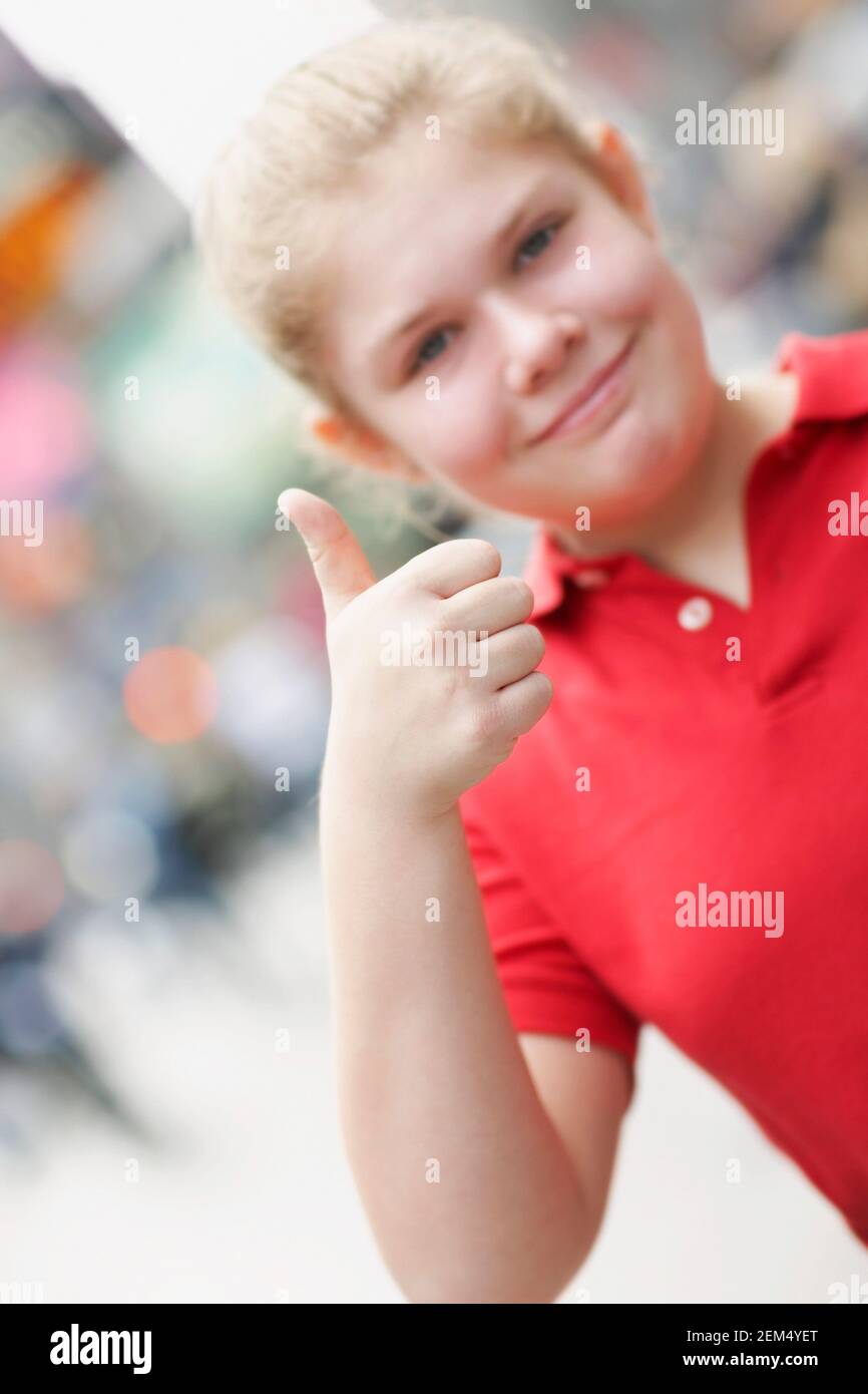 Portrait of a teenage girl showing thumbs up sign Stock Photo - Alamy