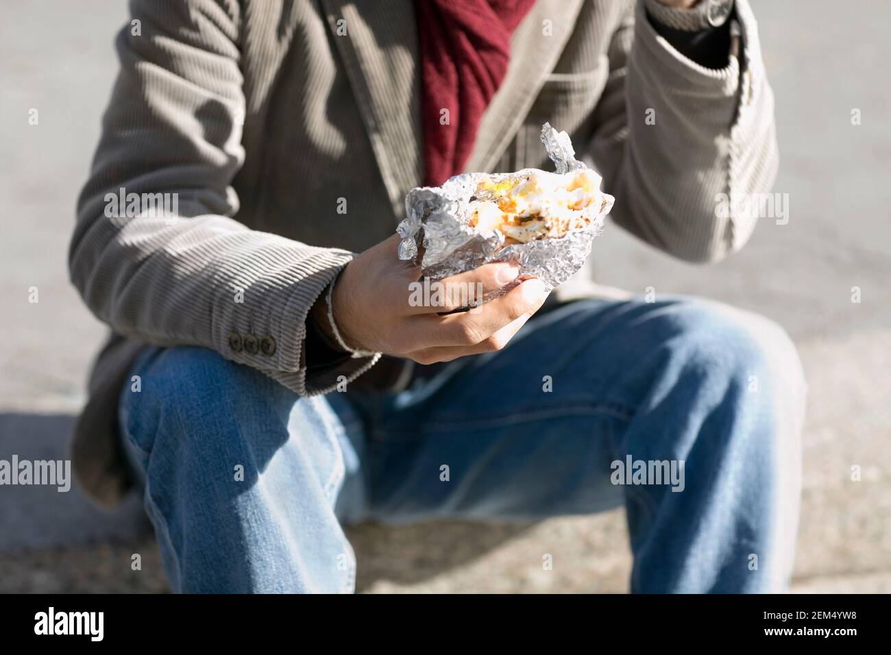 Close-up of a man holding a burger Stock Photo