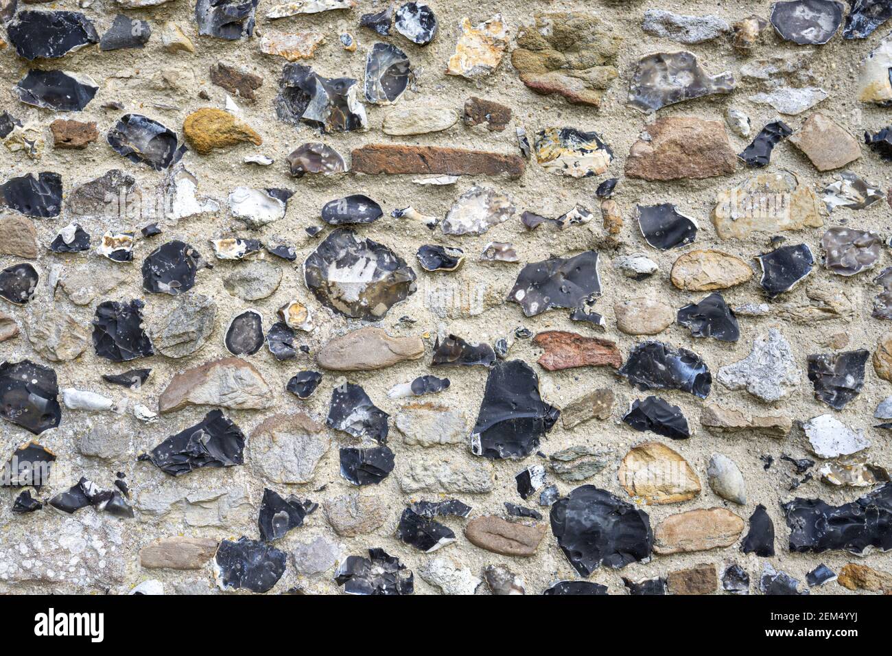 A close up of knapped flint in the outer wall of the church of St Mary the Virgin in the village of Preston St Mary, Suffolk UK Stock Photo