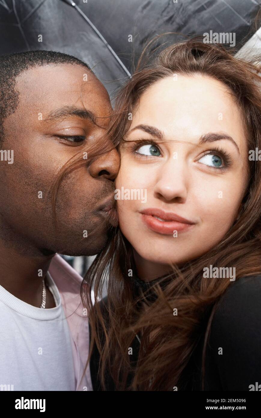 Closeup of a young man kissing a young woman Stock Photo Alamy