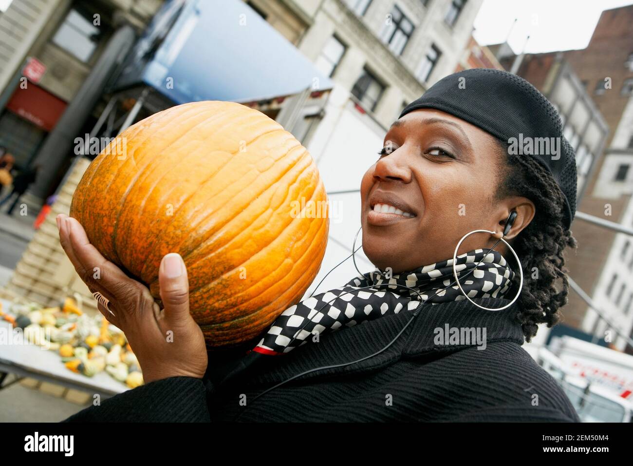 Portrait of a mid adult woman holding a pumpkin Stock Photo