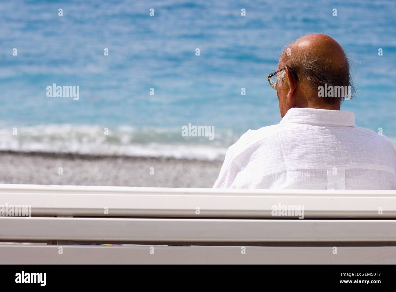 Rear view of a senior man sitting on a bench, Barcelona, Spain Stock Photo