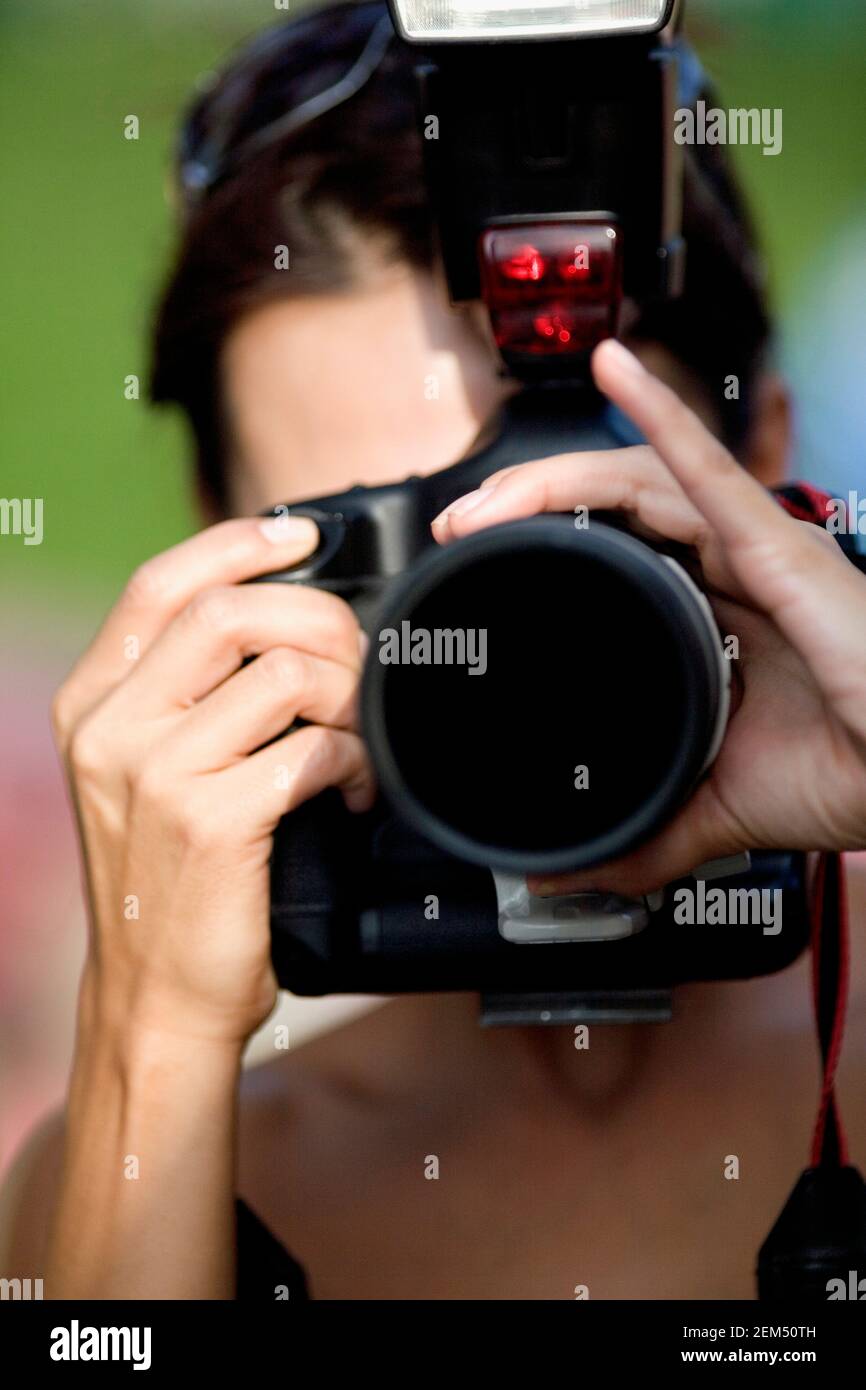 Mid adult woman taking a picture with a camera Stock Photo
