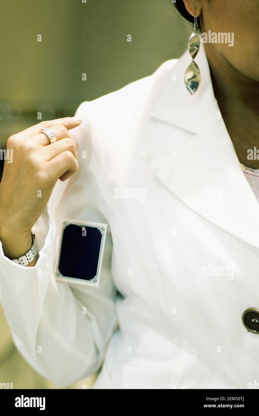 Mid section view of a mid adult woman trying on a coat, Barcelona, Spain Stock Photo
