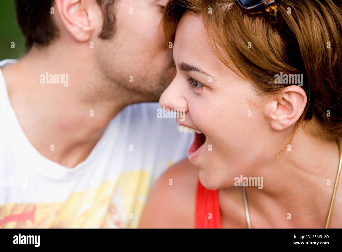 Young man kissing a young woman Stock Photo - Alamy