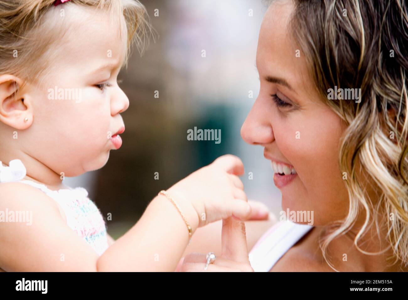 Close-up of a young woman smiling with her daughter Stock Photo