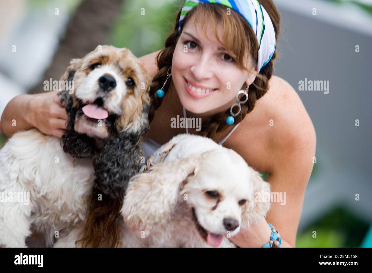 Portrait of a mid adult woman holding two dogs Stock Photo