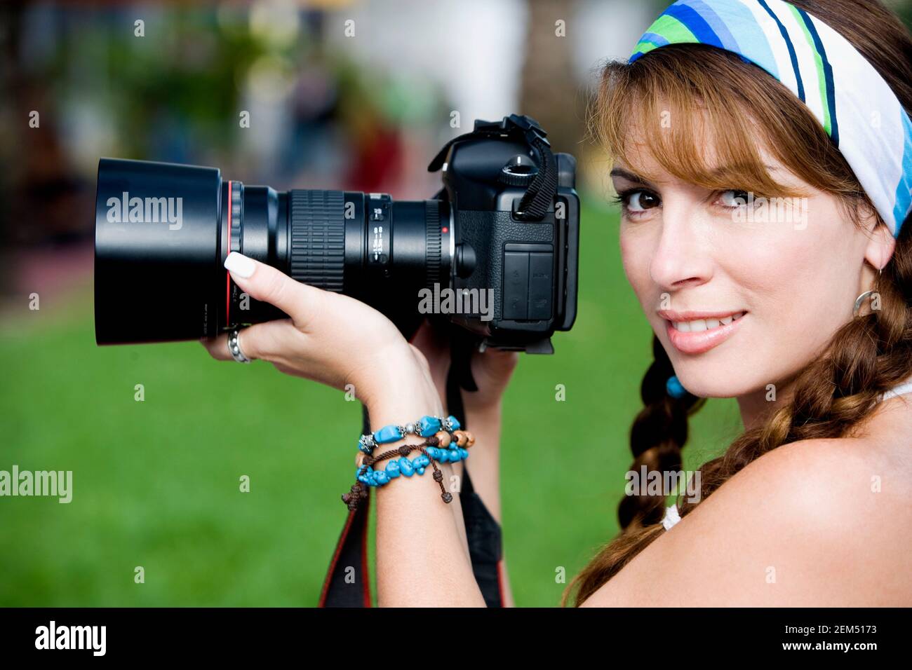 Portrait of a mid adult woman holding a camera Stock Photo