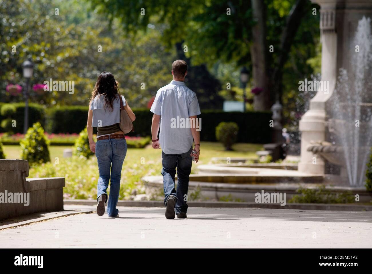 Man woman walking park rear hi-res stock photography and images - Alamy