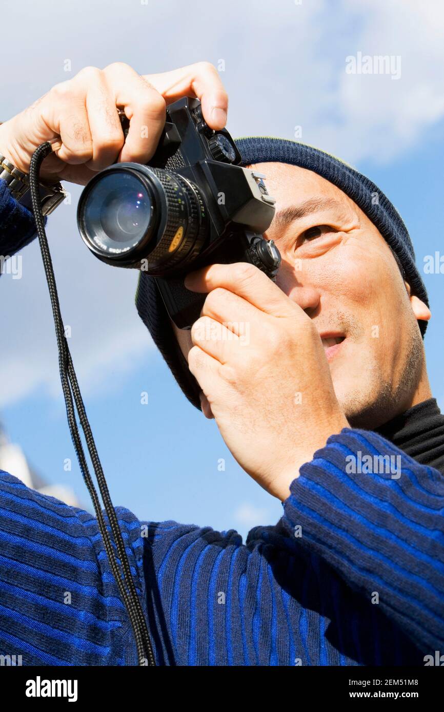 Low angle view of a mid adult man taking a picture Stock Photo