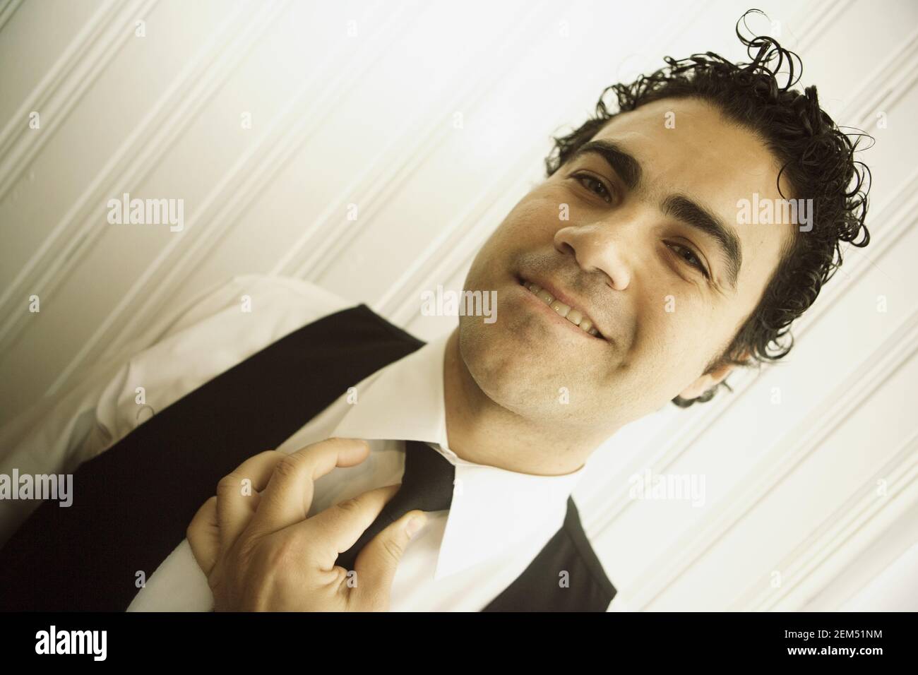 Portrait of a waiter adjusting his tie Stock Photo