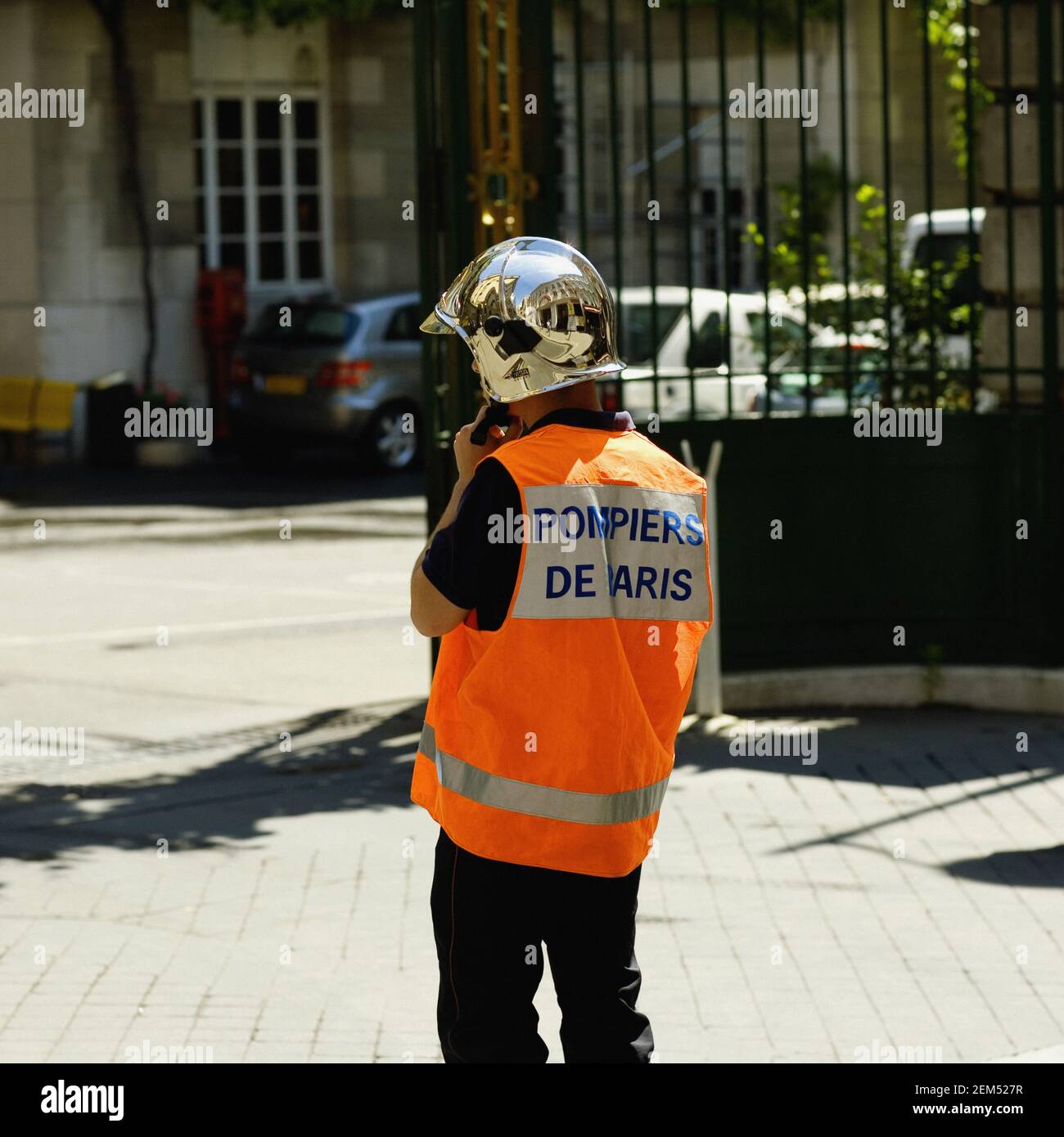 Rear view of a fireman standing, Paris, France Stock Photo
