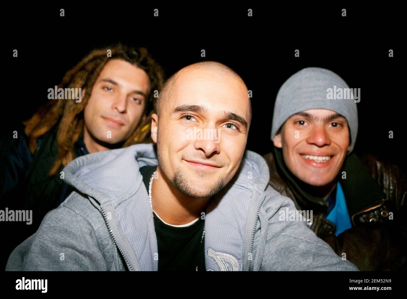Portrait of three young men smiling Stock Photo - Alamy