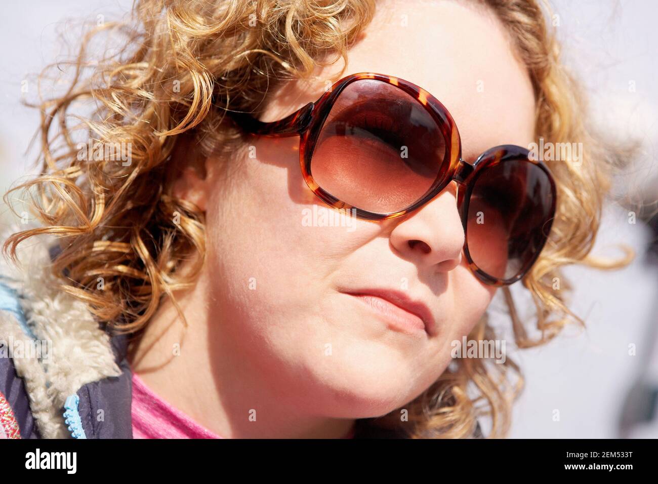 Close-up of a young woman wearing sunglasses Stock Photo - Alamy