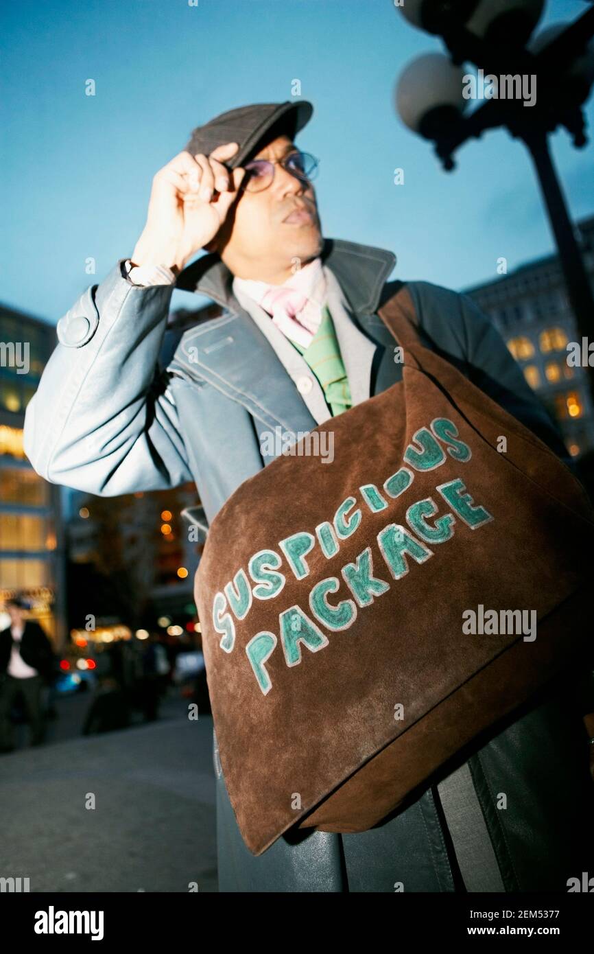 Low angle view of a mid adult man carrying a bag Stock Photo