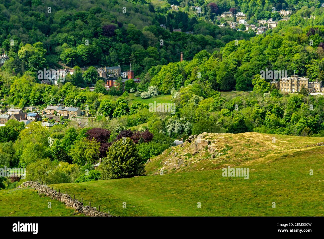 Landscape with trees and hills in early summer at Cromford in the Peak District Derbyshire Dales