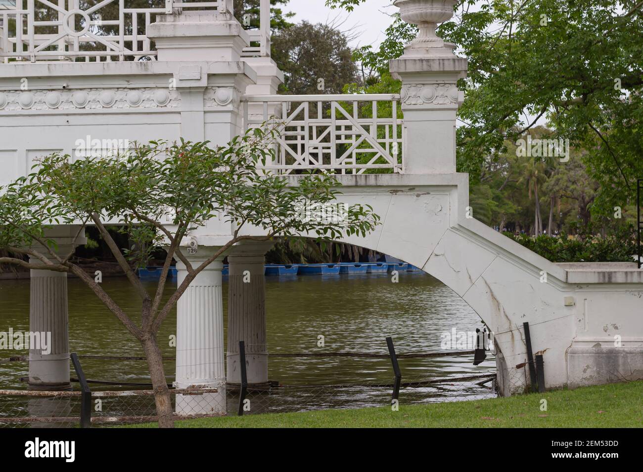 Old white bridge over the lake in the city park. Stock Photo