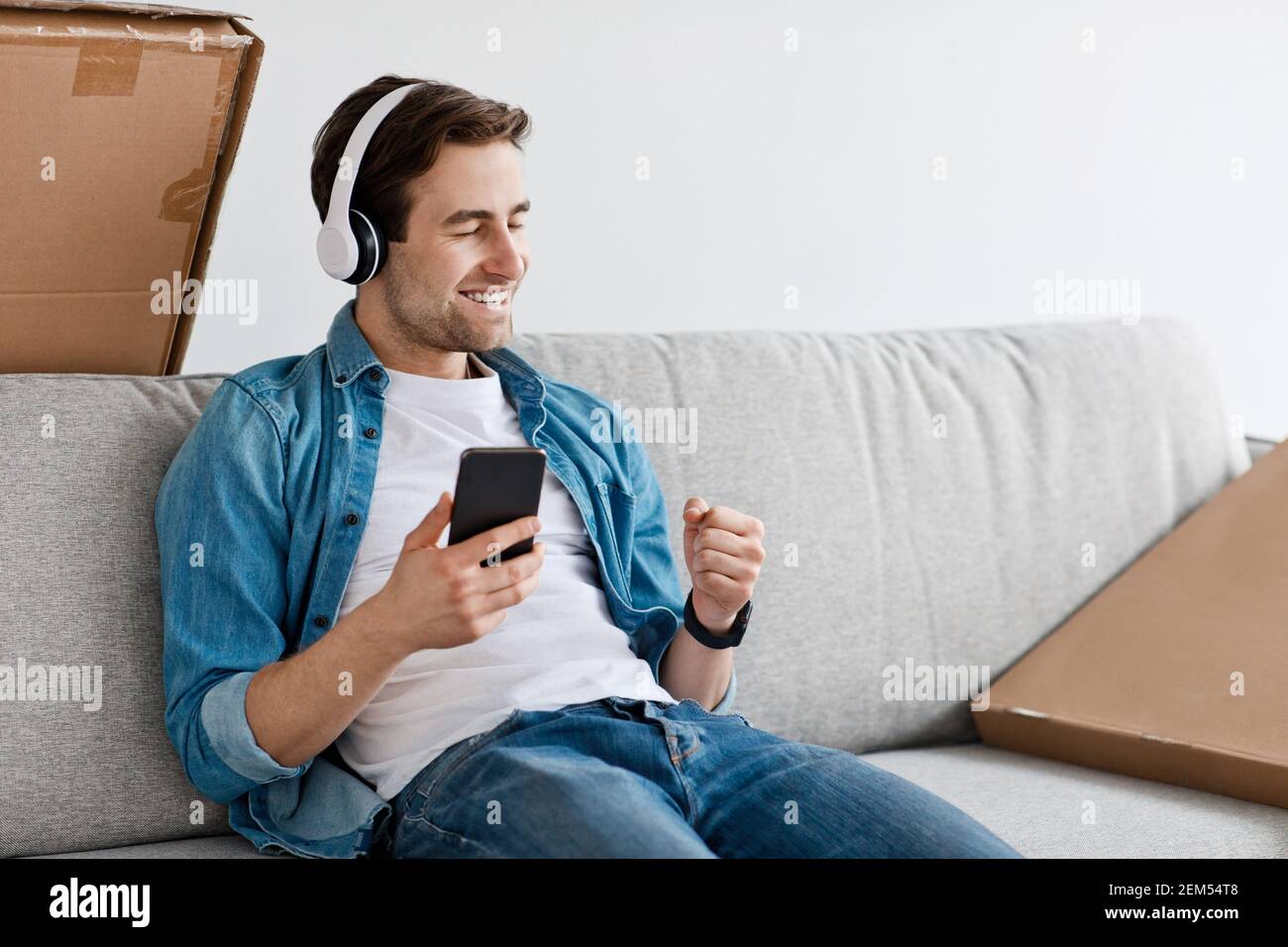 Moving, unpacking furniture, taking break and resting in new home Stock