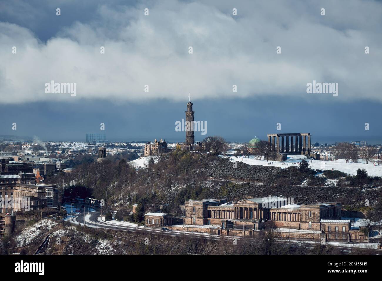 View of downtown of Edinburgh in winter with historic landmarks under dramatic skies. Calton Hill in the snow, Edinburgh, Scotland, UK Stock Photo