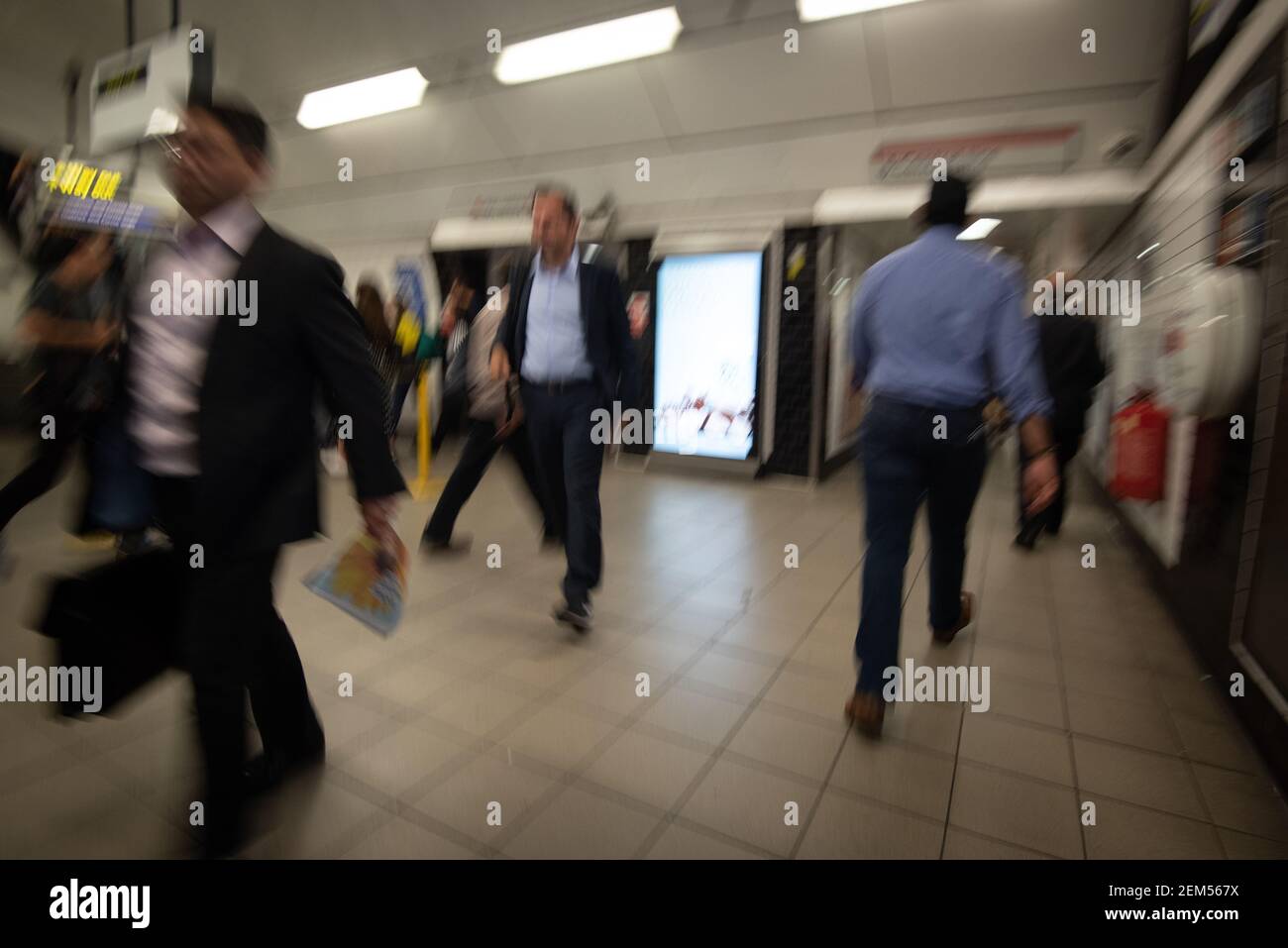 Random unrecognized people at the underground railway tube station during rush hour. Stock Photo