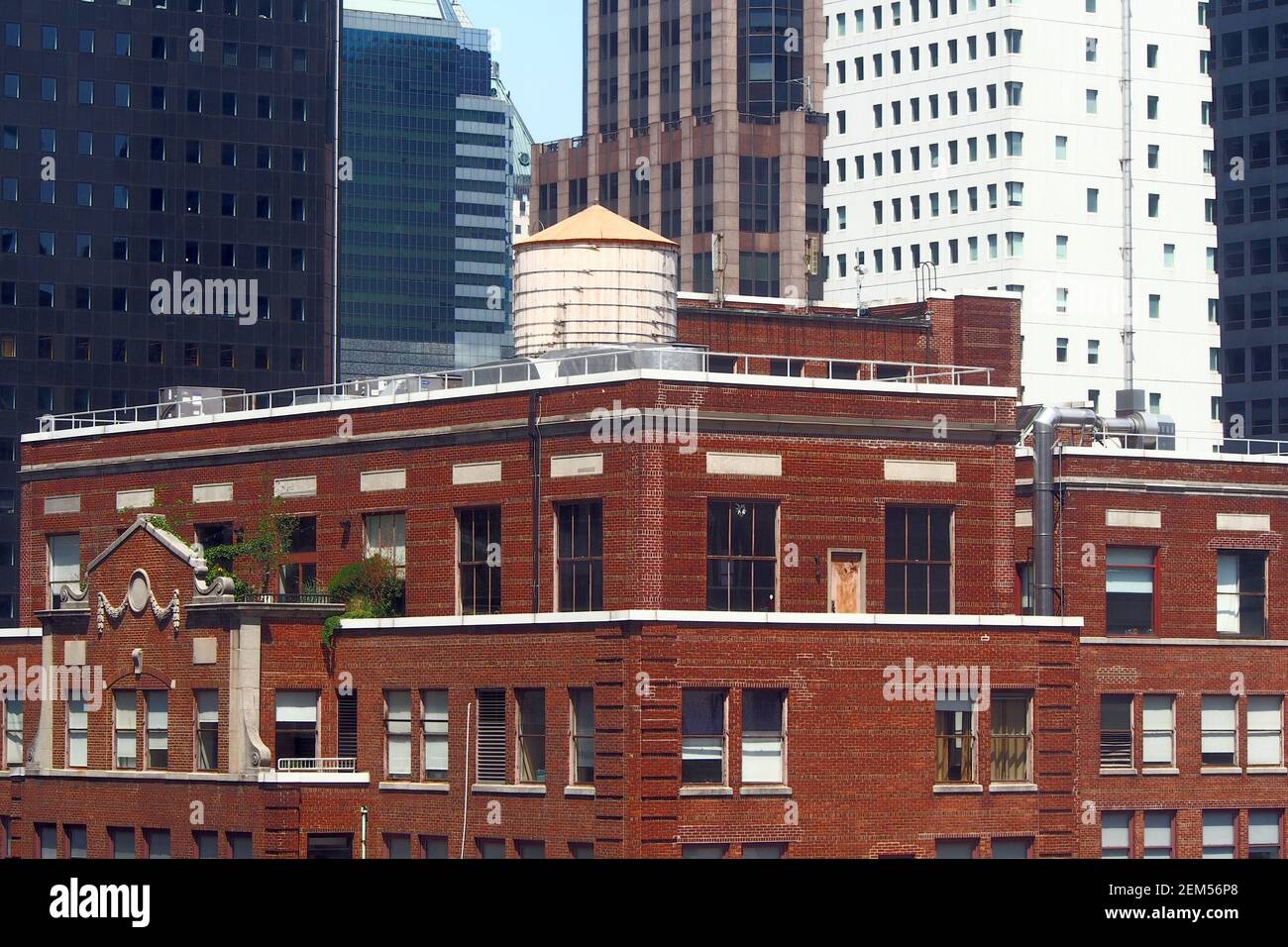 Water tank on top of a penthouse on the roof of an older building among